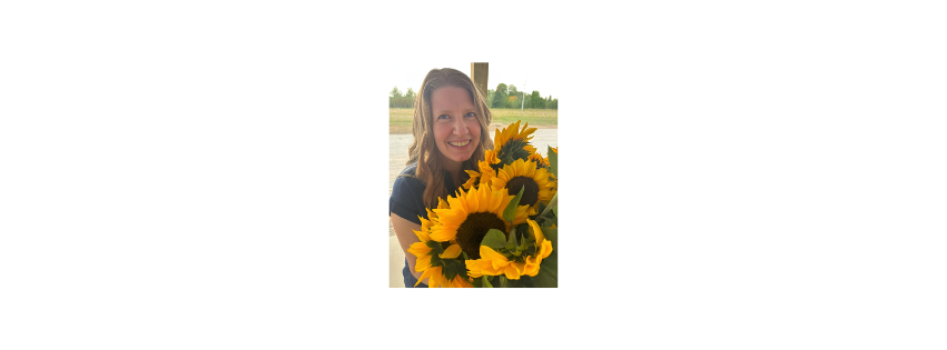 Sarah McGuire holding a bouquet of fresh sunflowers that she grew on MI Lavender Farm in Northeast Michigan, near Alpena Michigan.